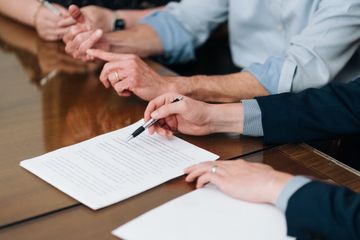A client signs documents at PLDR Law